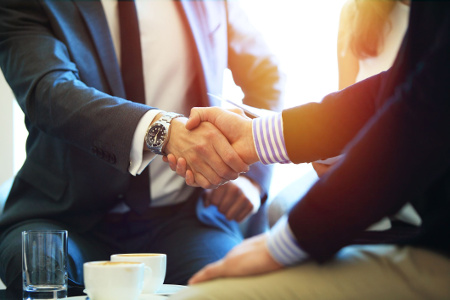 Photo of two businessmen shaking hands.