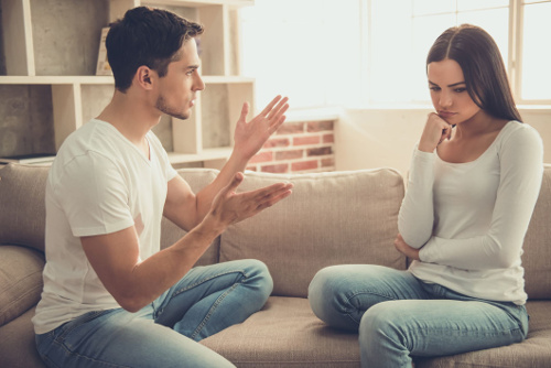 Photo of a couple having a disagreement where one is thinking about what the other is saying.